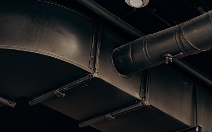 Rectangular duct with a round branch duct and its damper handle.